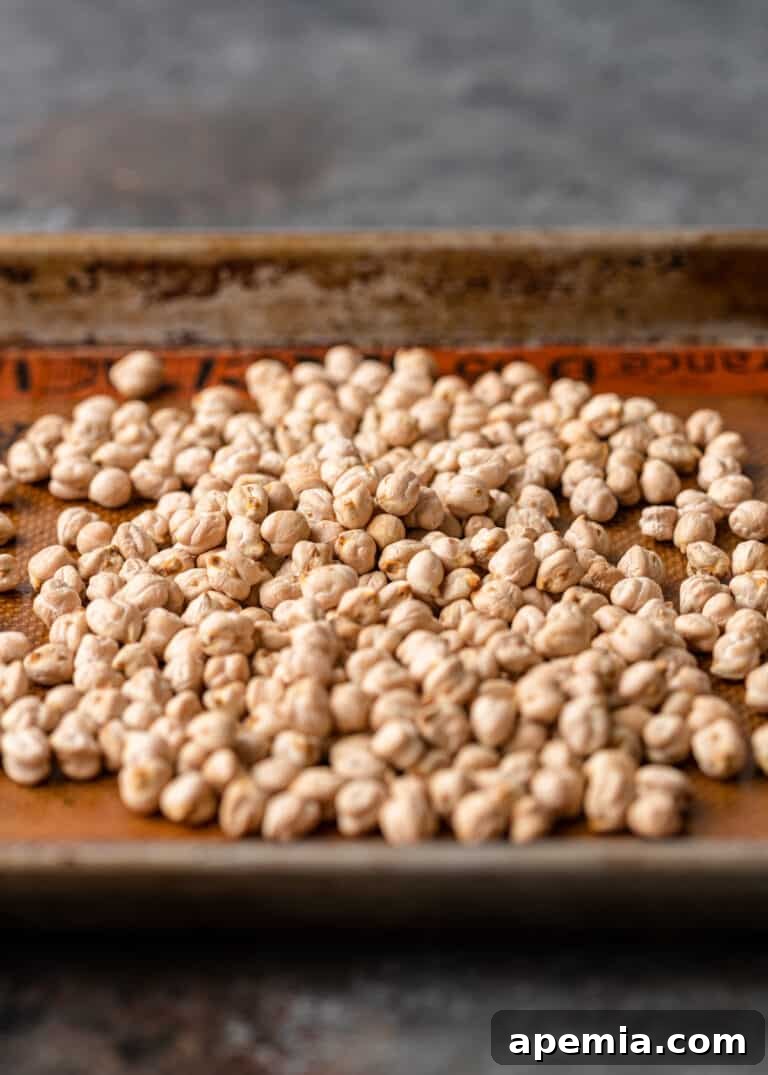 Close-up of dried chickpeas being sorted, emphasizing the importance of removing debris