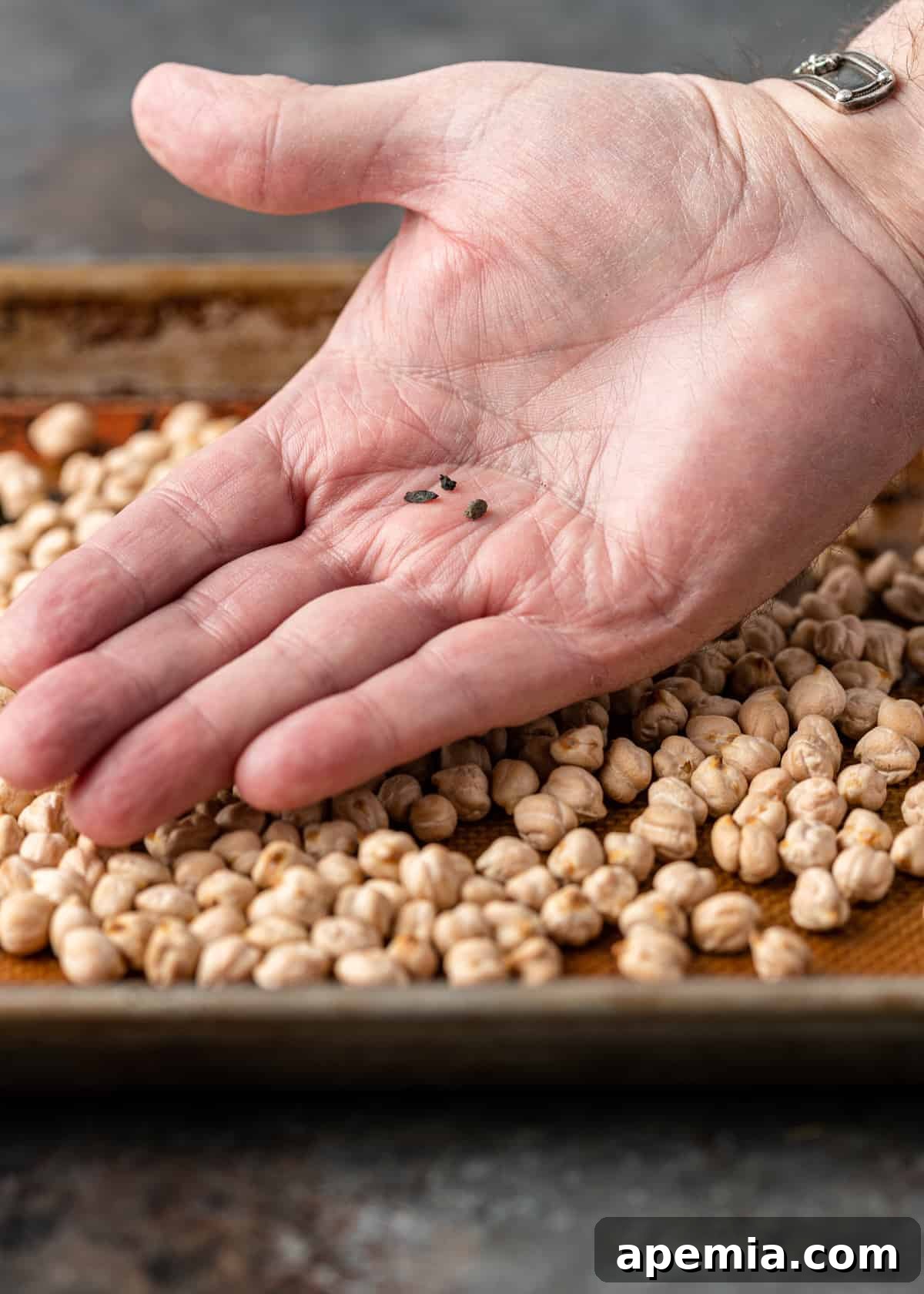 A wider shot of dried legumes being sorted on a surface, preparing them for cooking