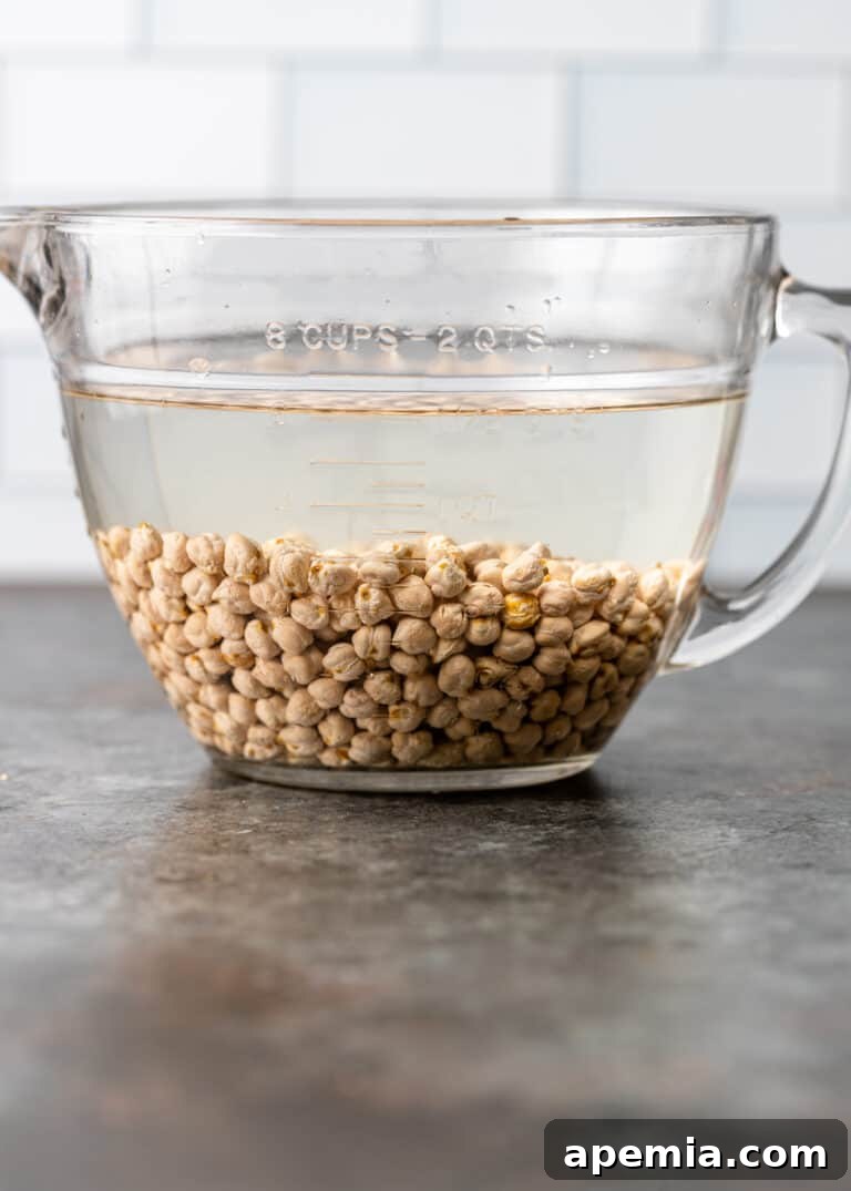 Dried garbanzo beans soaking in water, preparing them for the cooking process