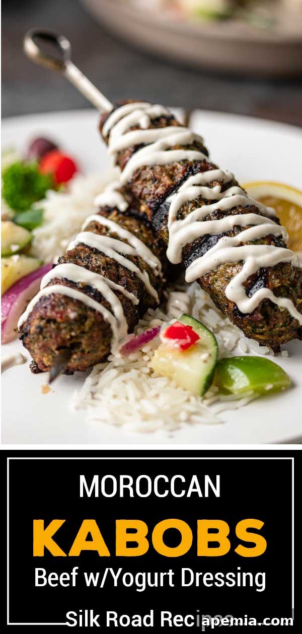 Titled image (and shown on skewers): Moroccan Beef with Yogurt Dressing - A visually appealing presentation of grilled kefta with a creamy sauce.