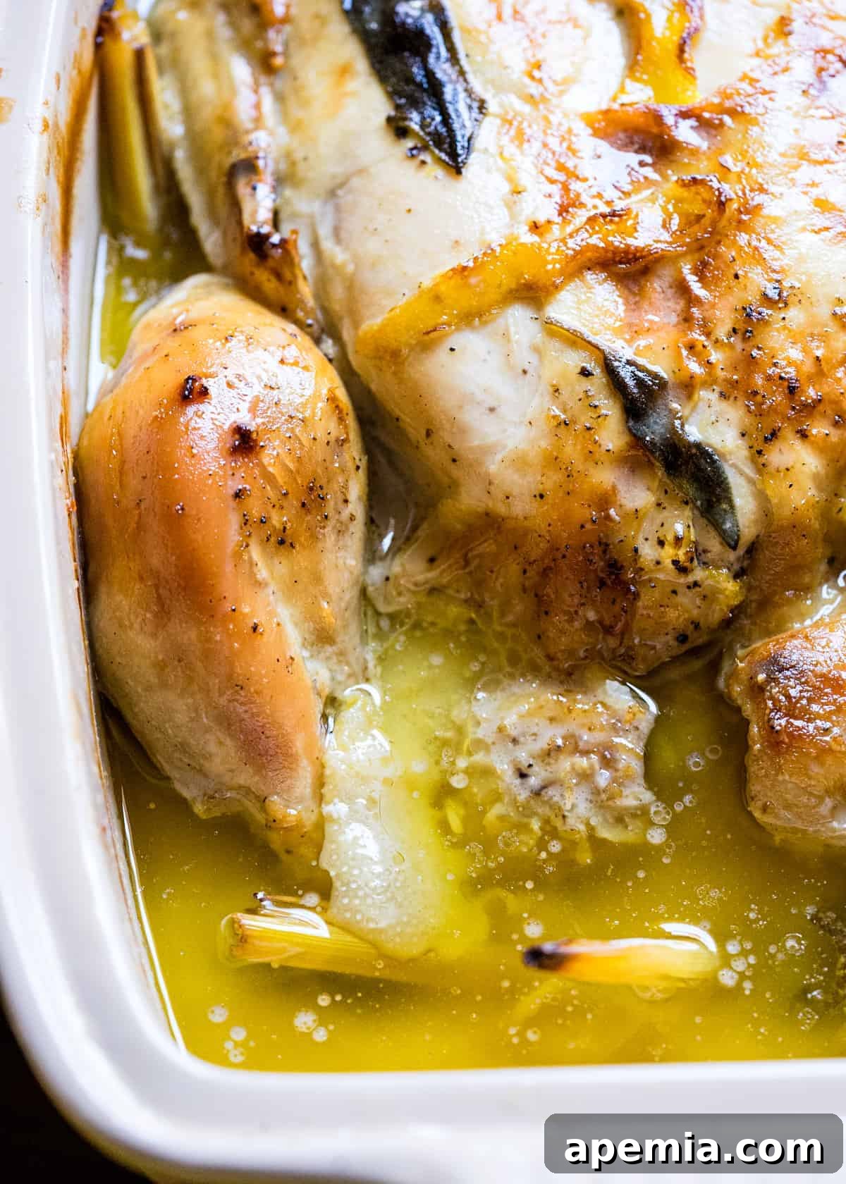 close up of Thai roasted chicken in pan with lemon butter