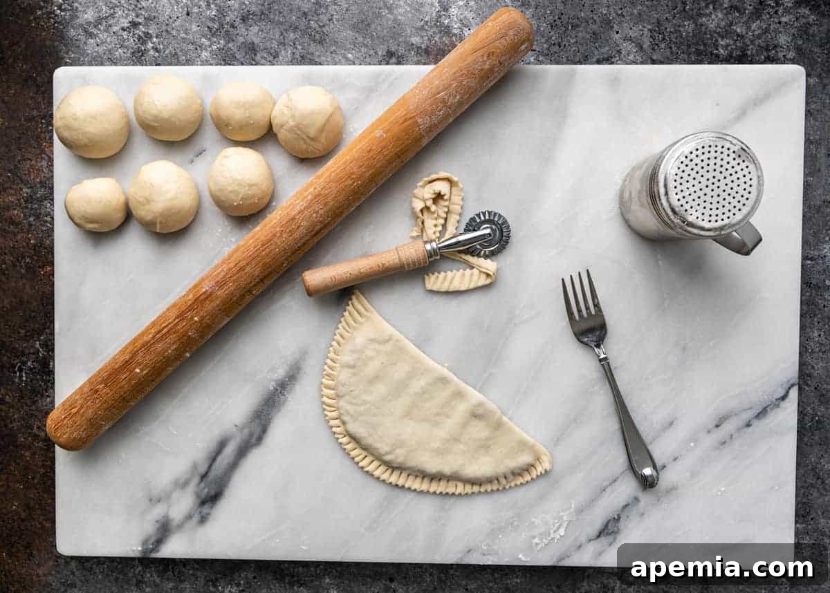 overhead image: pastry dough and kitchen tools for making Russian meat hand pies
