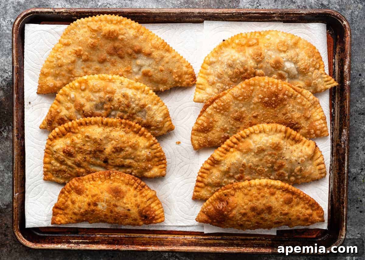 overhead: 8 savory fried turnovers on baking sheet