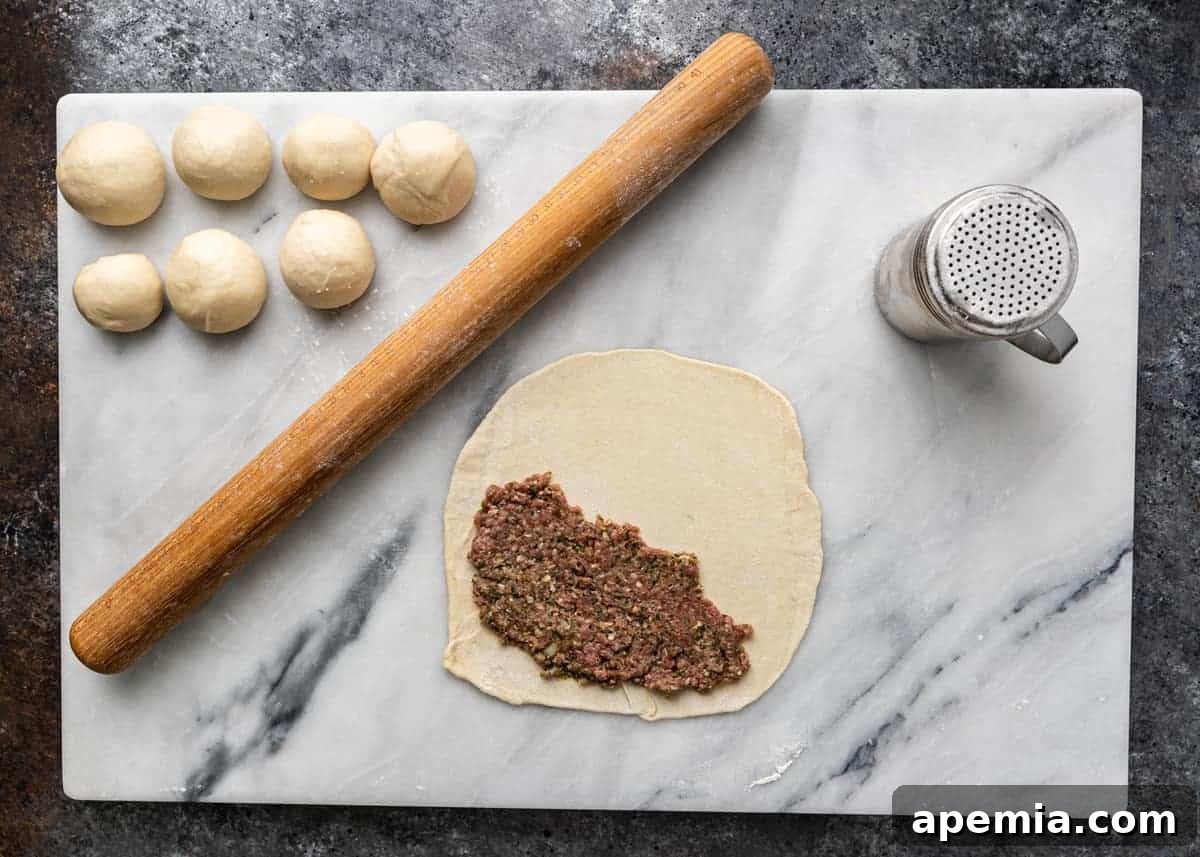 overhead image: ground beef filling on pastry dough for meat hand pies