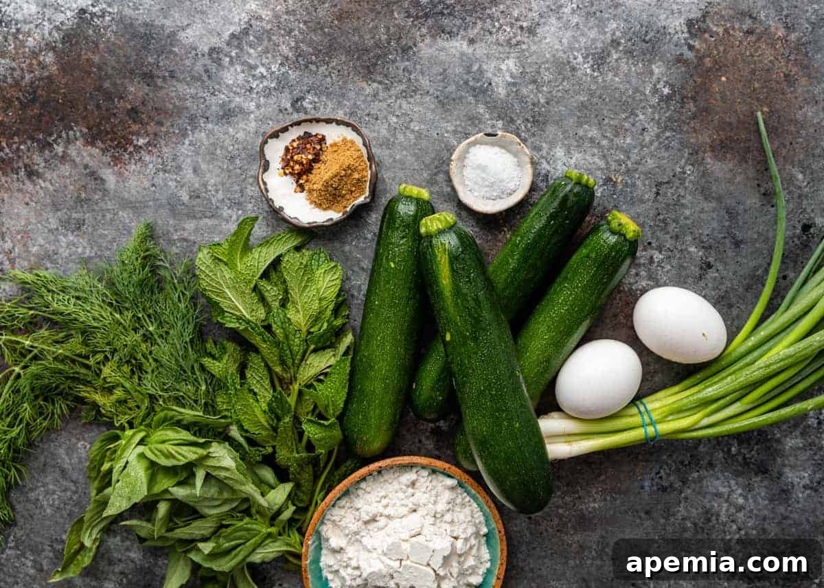 4 whole zucchini courgette, fresh herbs, eggs, scallion, white flour and spices to make fried squash patties