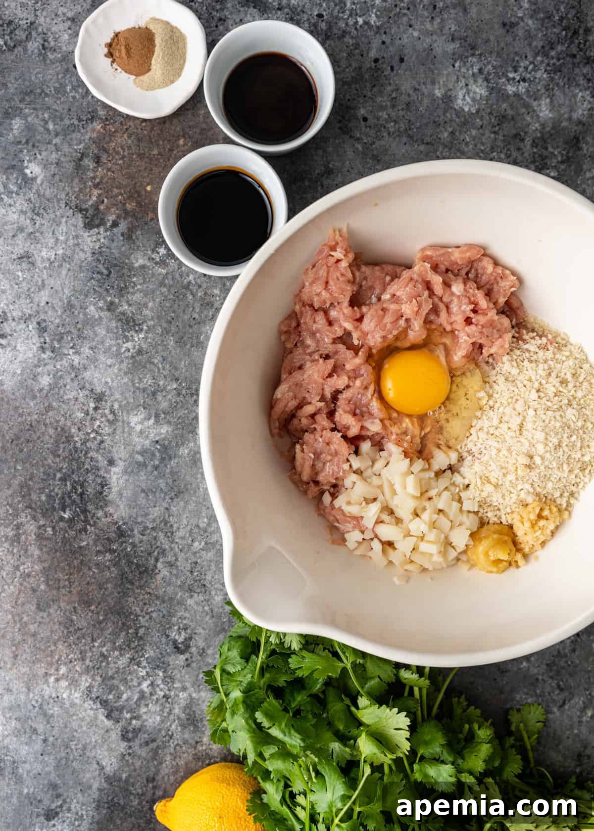 overhead: bowls of ingredients to make Chinese chicken meatballs
