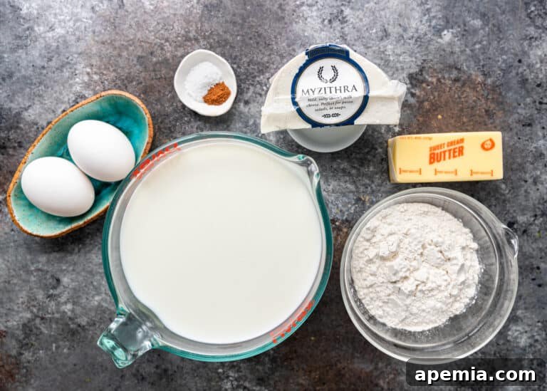 large measuring cup of milk next to other ingredients for pastitsio white cheese sauce