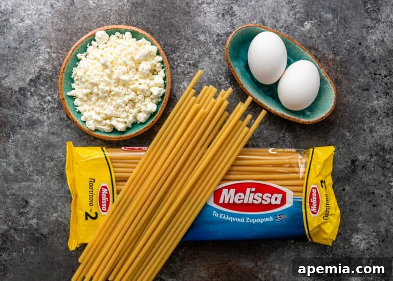 overhead: 2 whole eggs, small plate of kefalotyri cheese and package of bucatini pasta