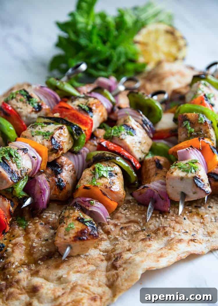 A collection of skewers featuring marinated and grilled vegetable and pork shish kabobs, ready to serve.