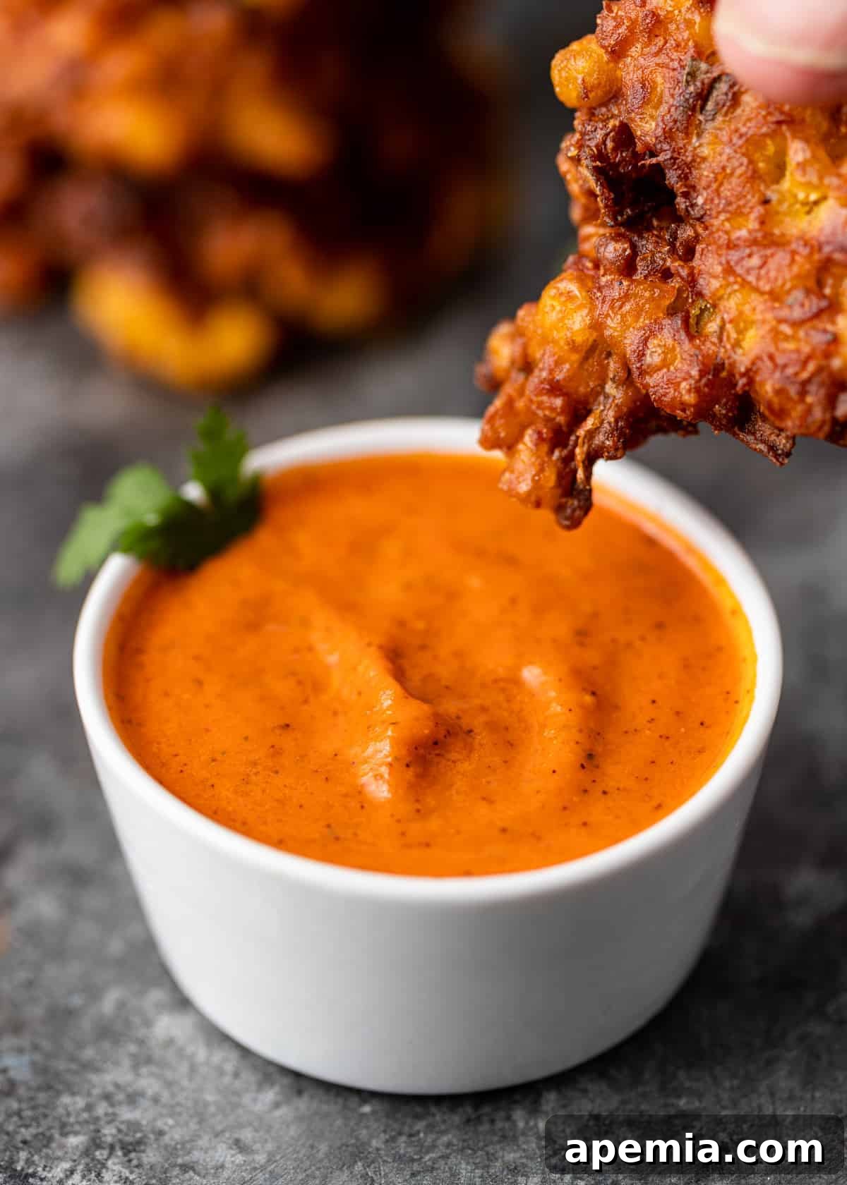 dipping vegetable pakora into my tomato pachadi recipe