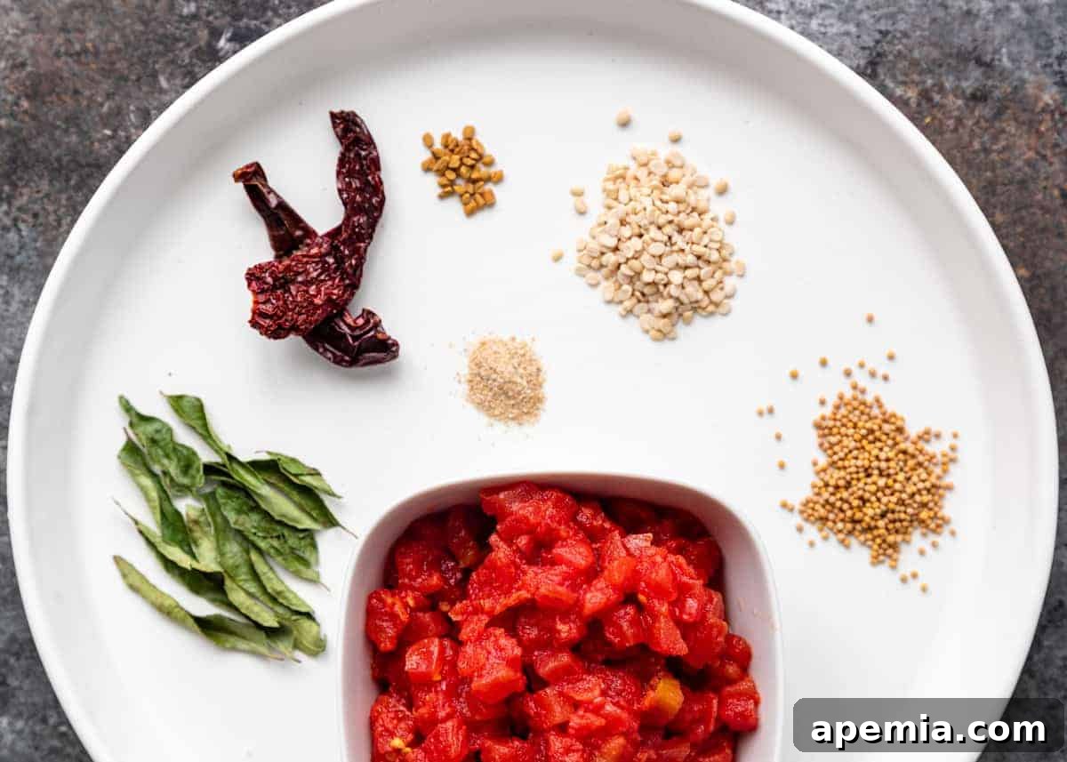 overhead: tomatoes and spices on white plate for tomato chutney recipe