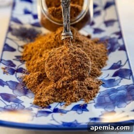 Close up image: ground Szechuan seasoning on spoon.