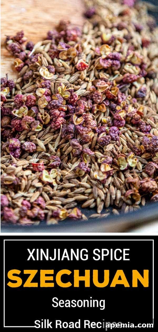 Titled image: bowl of whole red peppercorns, cumin seeds, and other whole spices for Asian seasoning, ready for grinding.