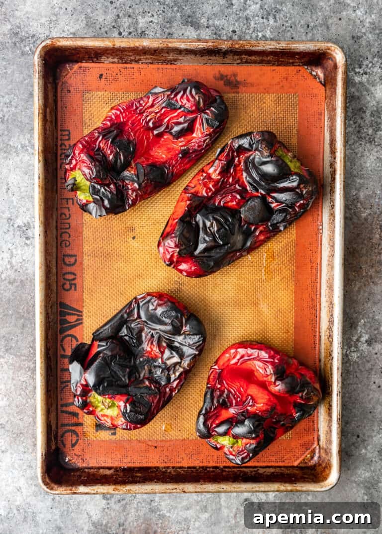 roasted red peppers on baking sheet for turkish pepper paste