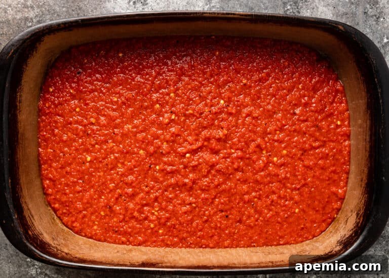 overhead: casserole stoneware dish of red sauce