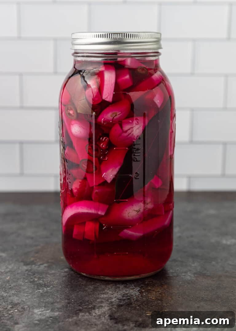 Side view of marinating turnips in brine on Day 3, with more noticeable pink color developing.