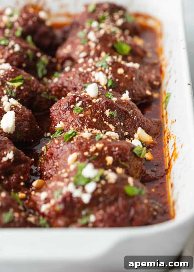 Greek lamb meatballs covered with rich tomato sauce and crumbled feta cheese, ready to be served