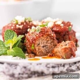 Close-up of Soutzoukakia Smyrneika served on a white dinner plate