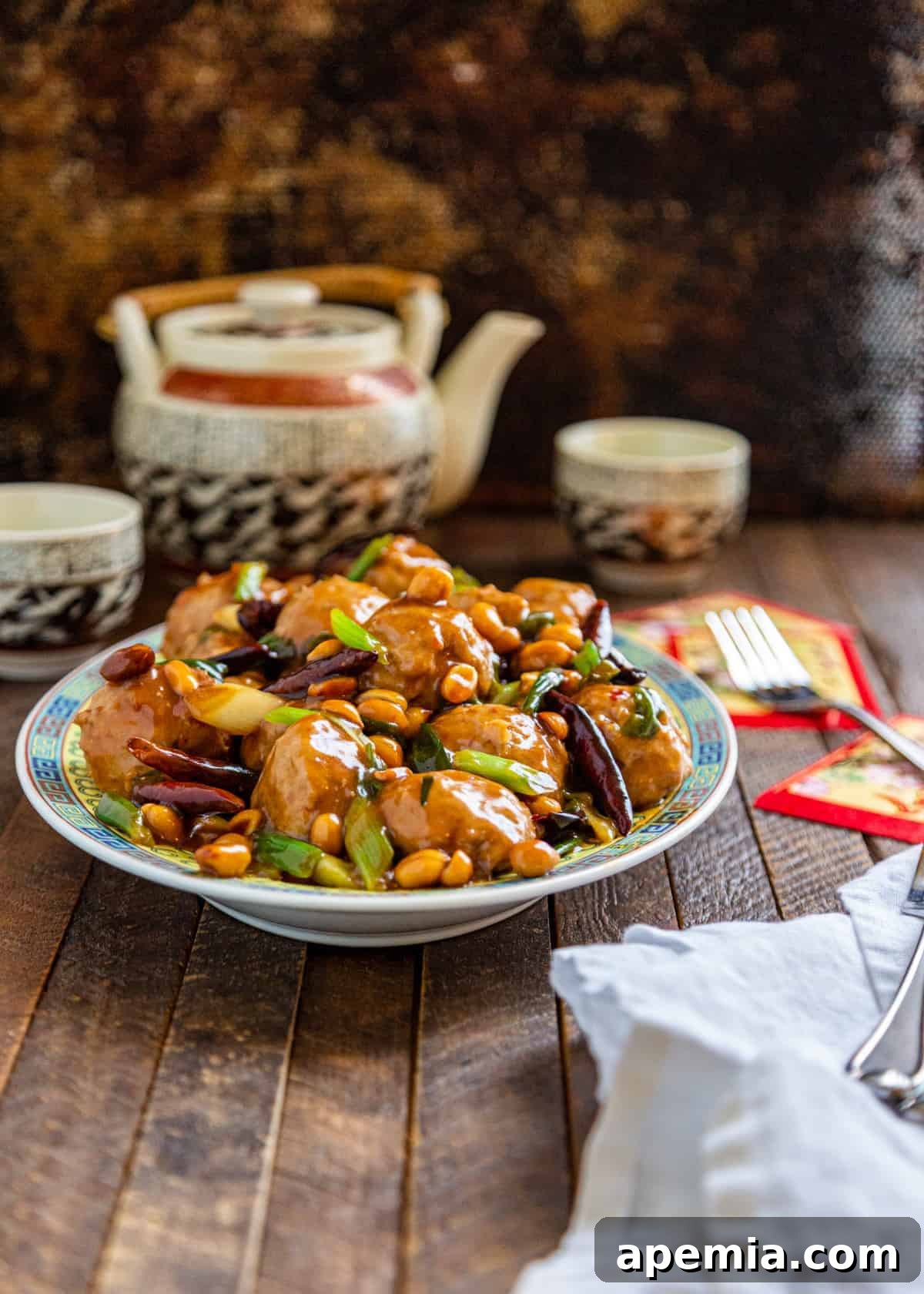 dish of kung pao Asian chicken meatballs on table top