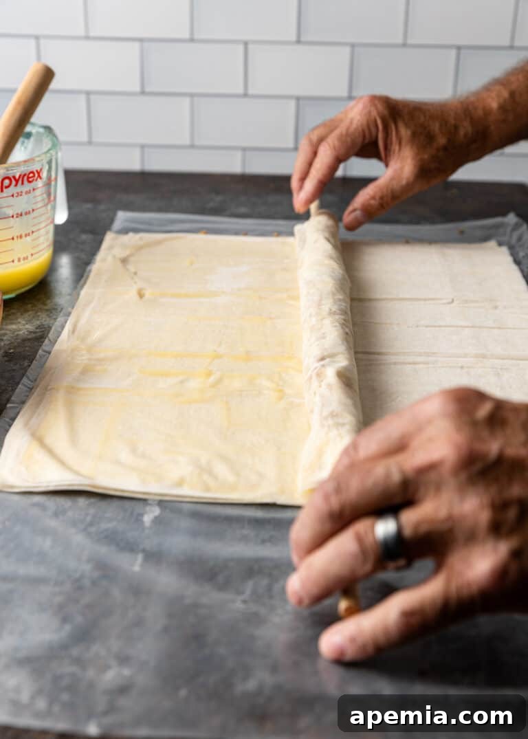 rolling sheets of phyllo for greek baklava rolls, combining layers