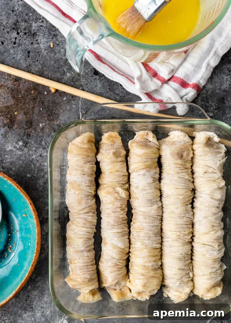 overhead: unbaked baklava in square glass baking pan, ready for baking