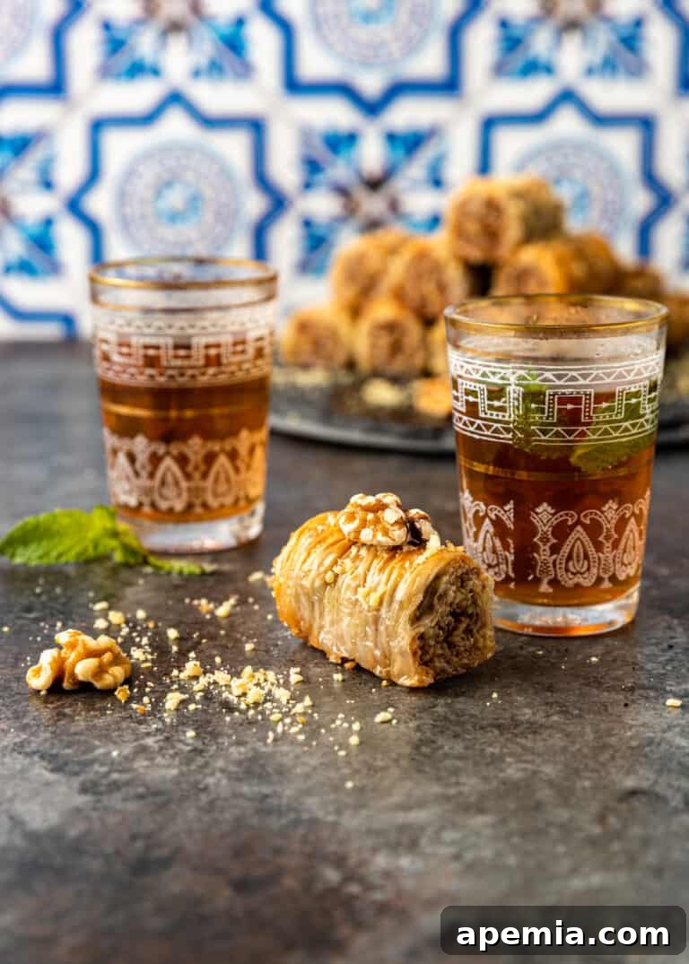 phyllo pastry dessert on kitchen counter with pieces of crushed walnuts, showcasing final presentation