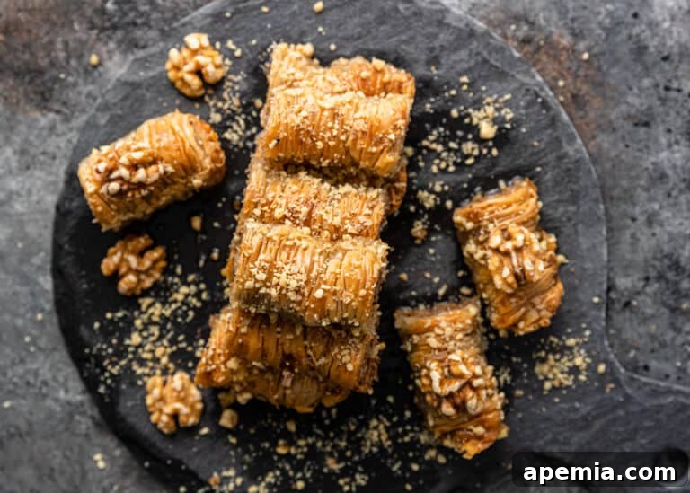 overhead: saragli on black platter with crushed nuts and syrup