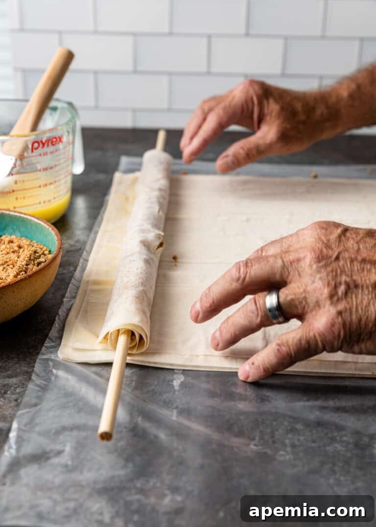 first roll of baklava phyllo completed on dowel