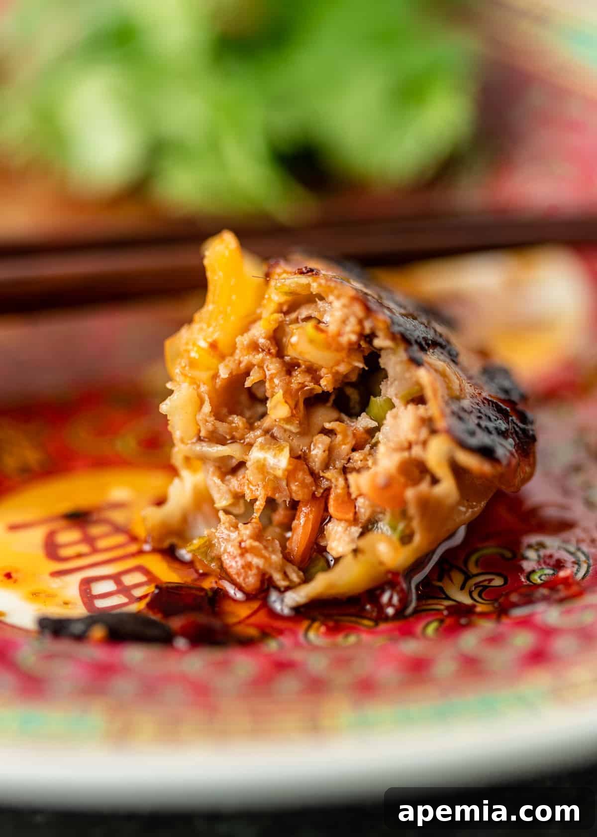 close up: inside of an Asian pork pot sticker, showing the succulent filling