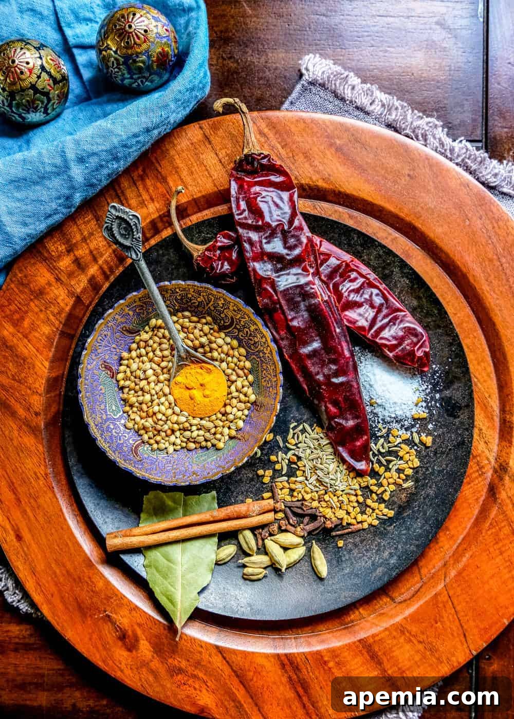 Chana Masala Spice Blend 3 A collection of whole spices and dried red chili peppers laid out to make a homemade chana masala spice blend recipe.