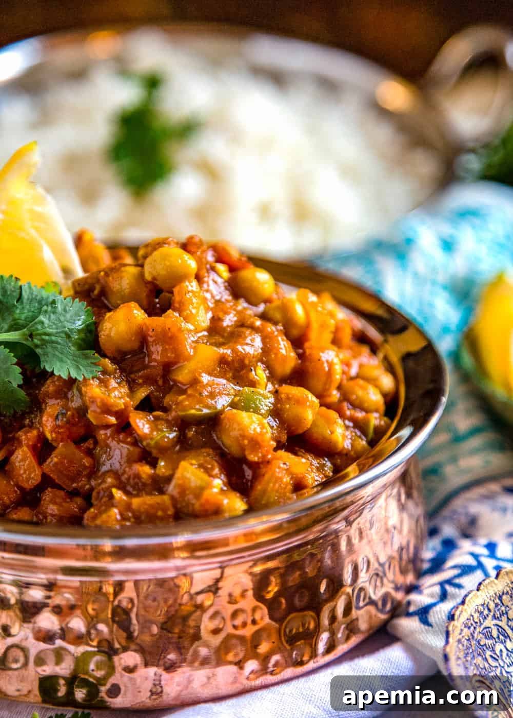 Chana Masala Spice Blend 4 A copper serving bowl filled with perfectly seasoned Indian chickpeas, garnished and ready to serve.