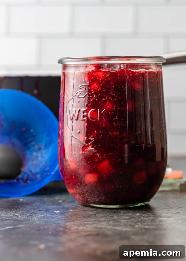 glass jar of homemade fruit relish, showcasing the finished cranberry apple chutney