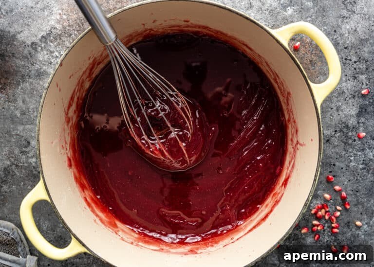 Adding syrup to the pomegranate base gradually, a little at a time, for the Turkish Delight recipe.
