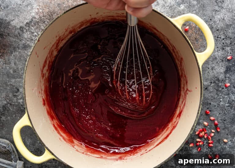 Continuously whisking pomegranate juice into the pot of sugar syrup for Lokum candies.