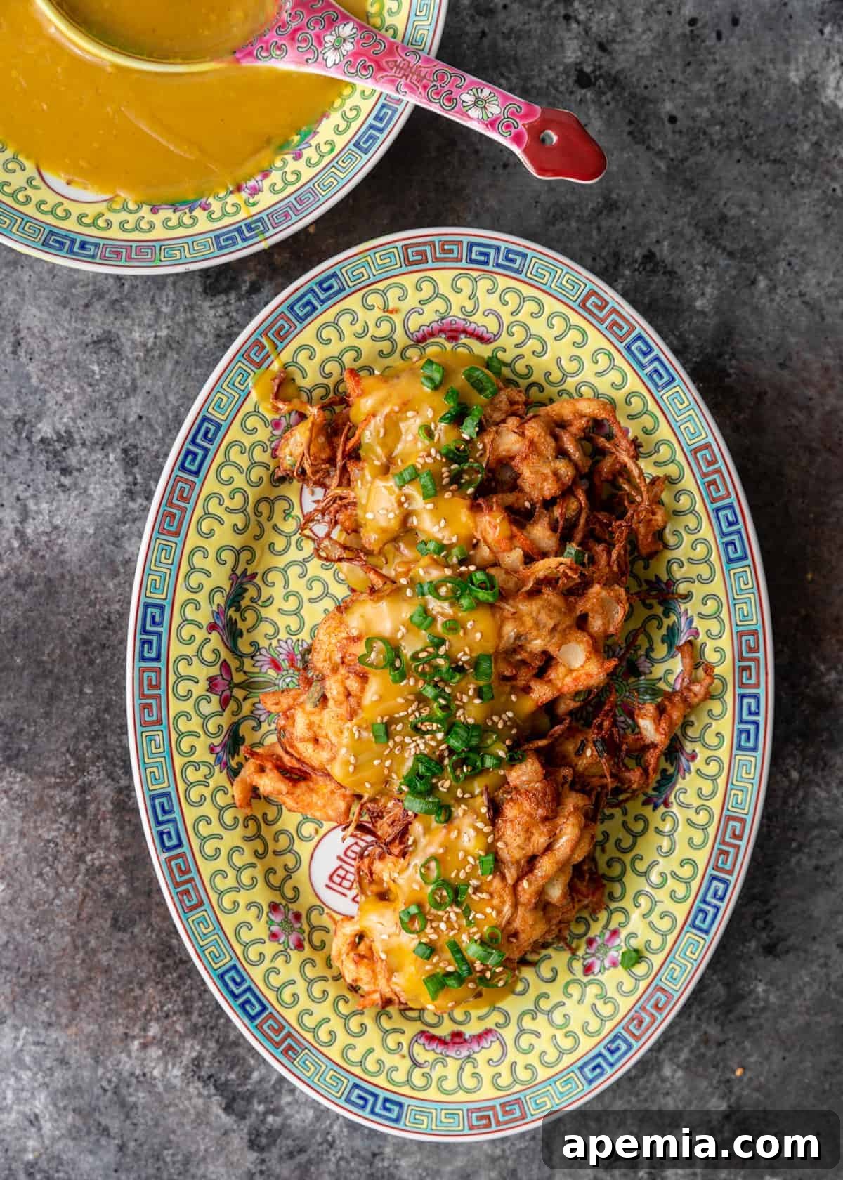 overhead: fried chicken egg foo young on a ceramic platter