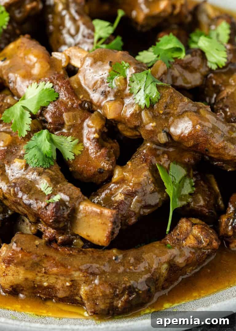 Close-up of tender Thai ribs glistening in rich coconut curry sauce
