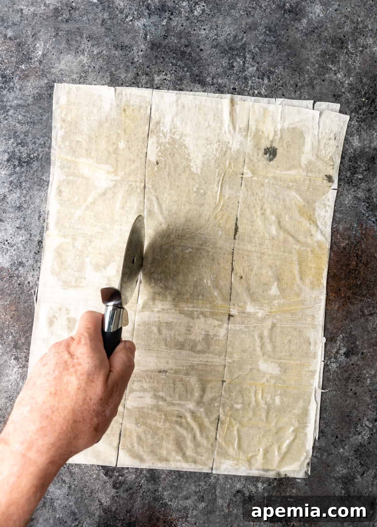cutting buttered filo sheets