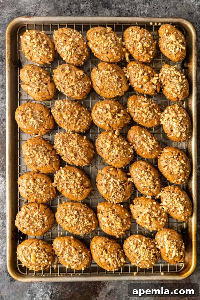 Overhead shot of a tray of Greek honey cookies Melomakarona, shaped and ready for the oven