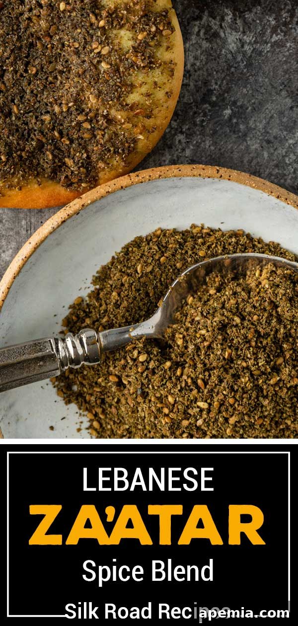 Crafting Your Own Lebanese Zaatar Blend 7 A beautifully composed vertical photo of a bowl of Lebanese Za'atar spice blend, with a small spoon, set against a rustic background, suitable for Pinterest sharing.