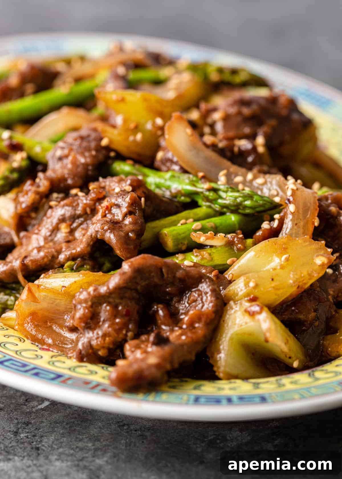Close-up view of my homemade beef with black bean sauce recipe, showcasing the tender beef strips, vibrant onion, crisp celery, and fresh asparagus.