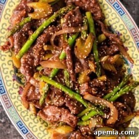 Overhead shot of a delicious Chinese stir fry with sirloin and vibrant vegetables, beautifully presented.
