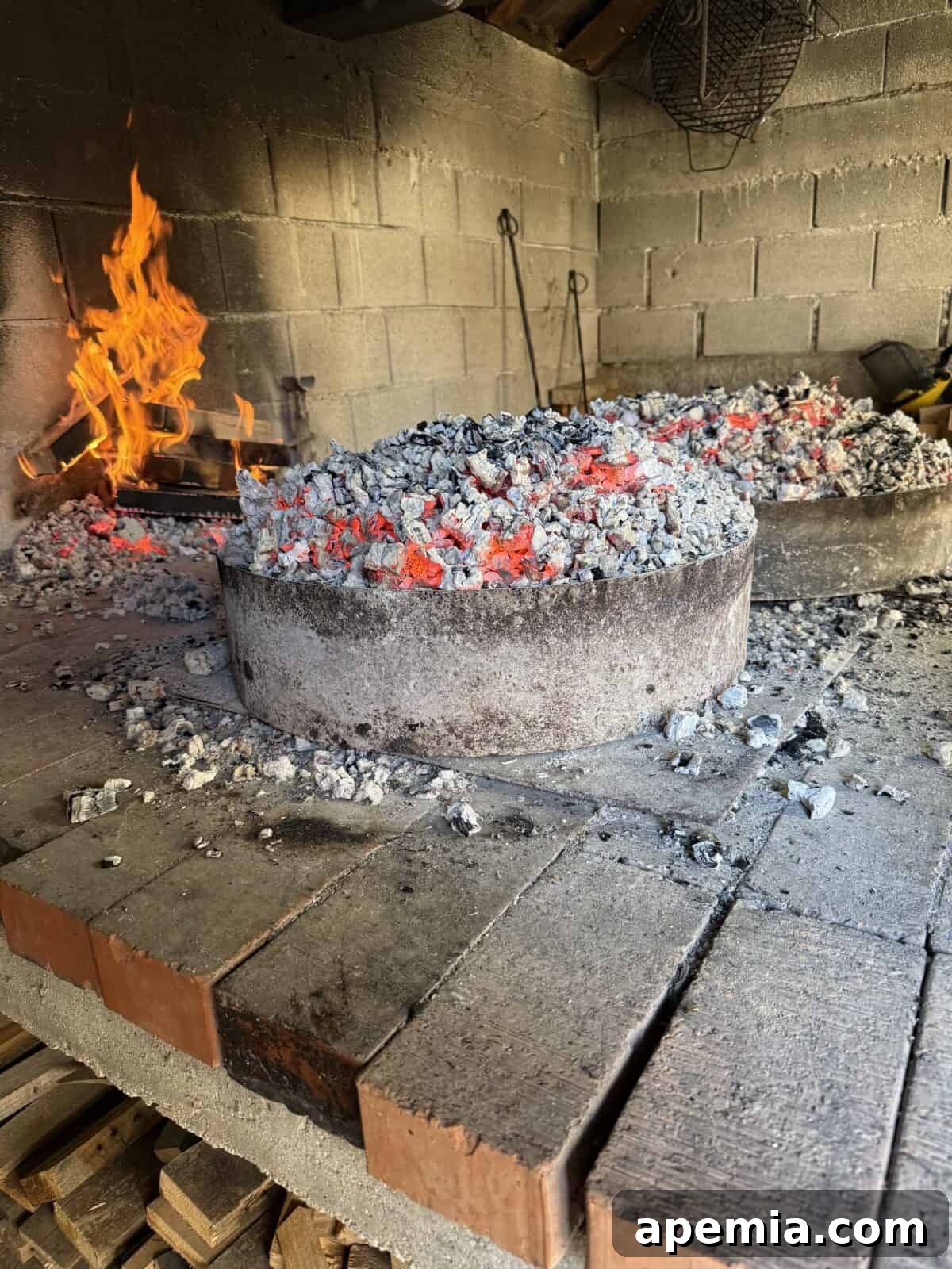 side view process shot: lowered domed iron lids cooking peka recipe