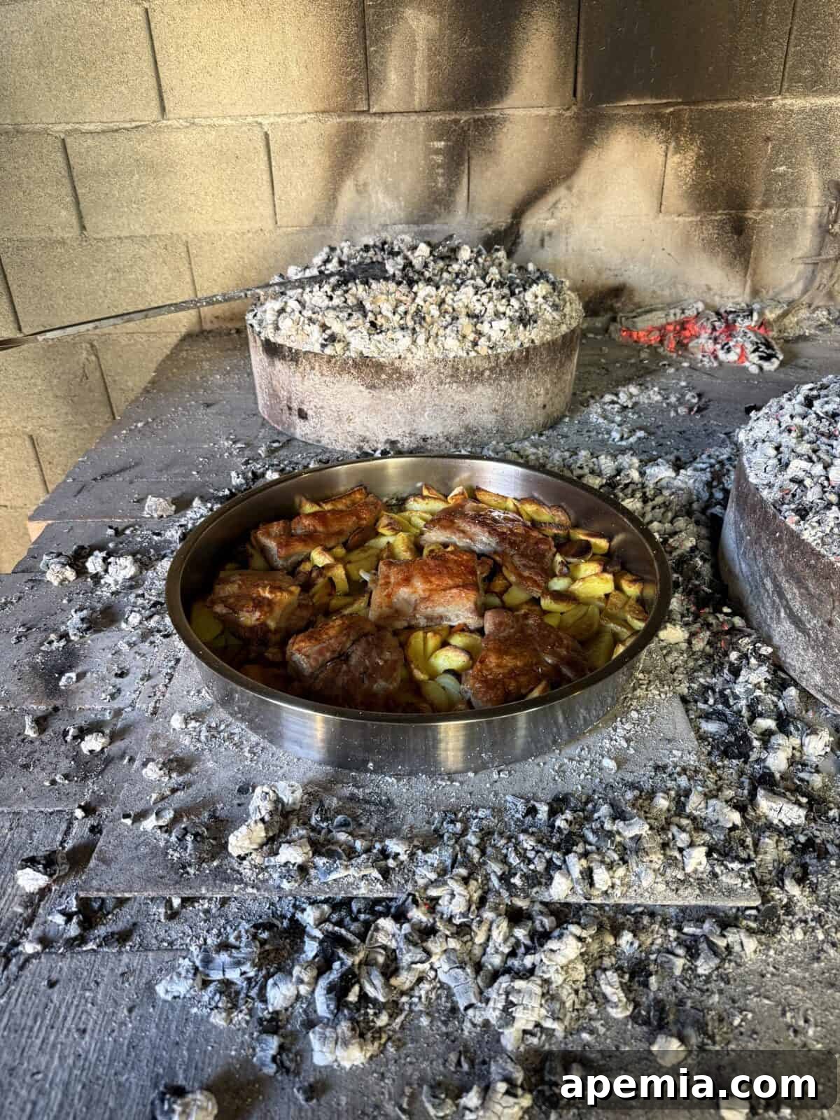 side view process shot: cooked croatian peka recipe in pot in smokehouse
