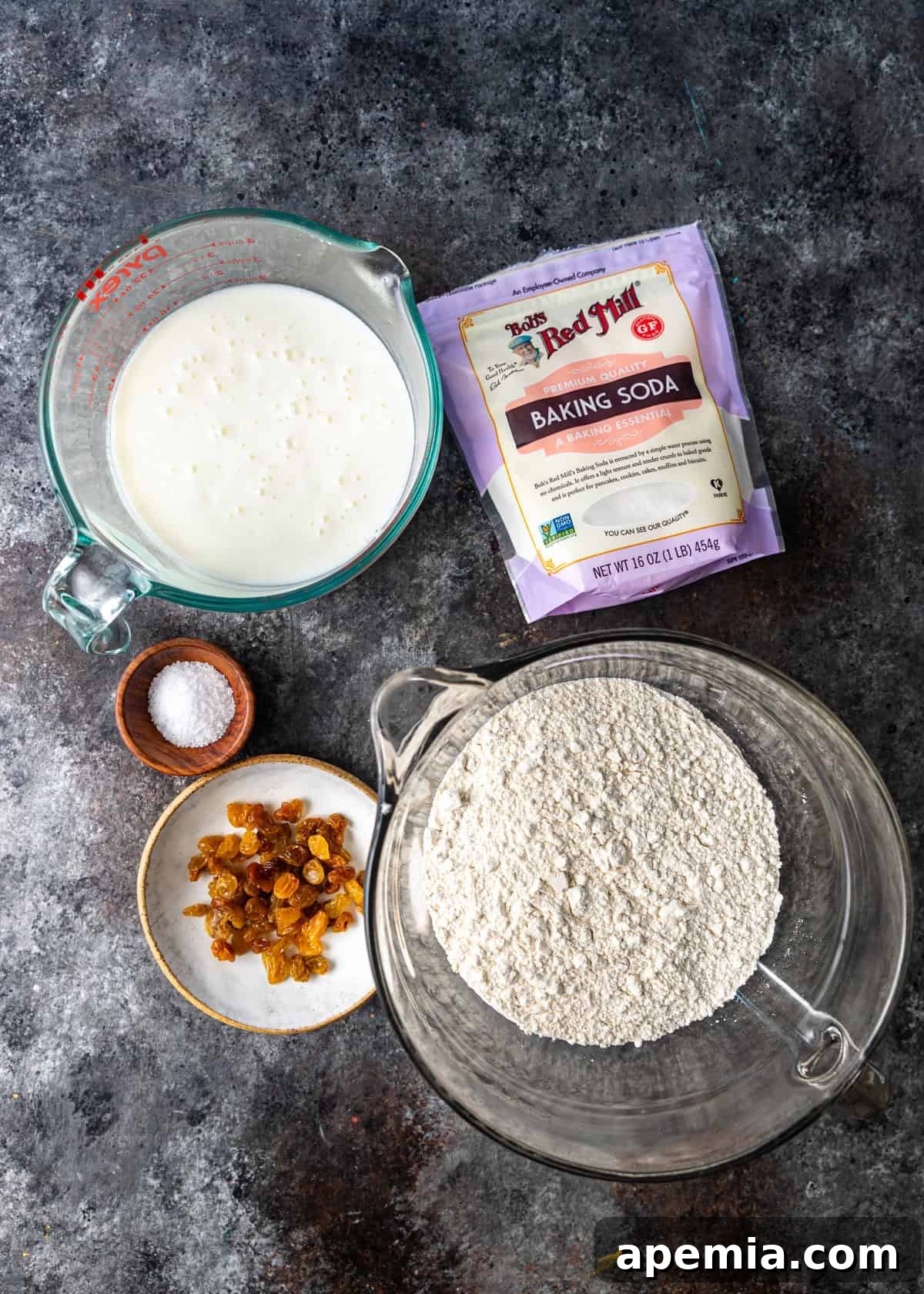 Overhead process shot displaying the key ingredients meticulously laid out to prepare the Irish soda bread recipe, ready for mixing.