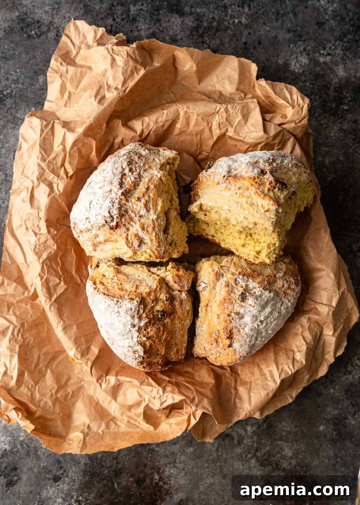Closeup overhead view of a freshly baked Irish soda bread, showcasing its rustic golden crust and inviting texture, ready for serving.