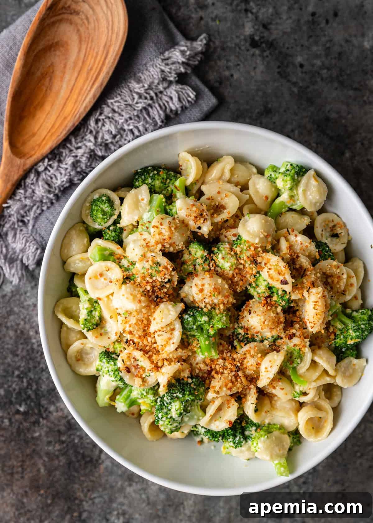 closeup overhead: ready to serve bowl of broccoli pasta topped with toasted breadcrumbs