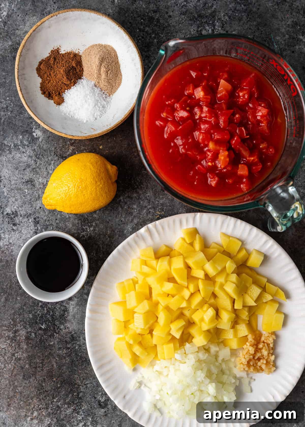 Overhead view of fresh ingredients laid out to make the flavorful Middle Eastern meatball stew recipe.