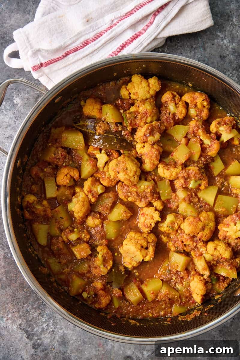 closeup overhead: potato cauliflower curry in pot