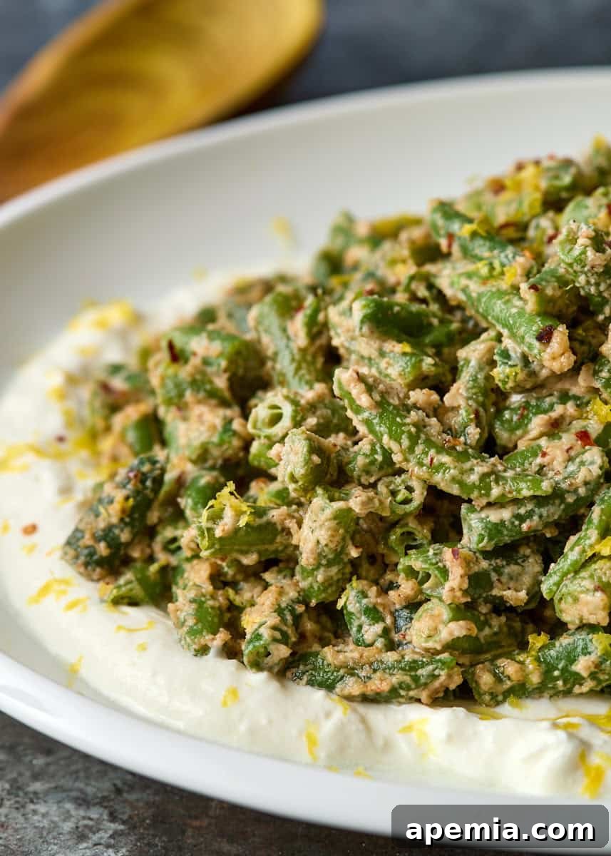side view: green beans with walnuts on serving platter