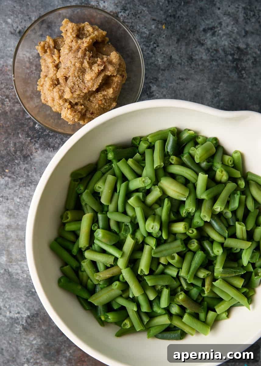 overhead: bowl of green beans and small bowl of walnut sauce